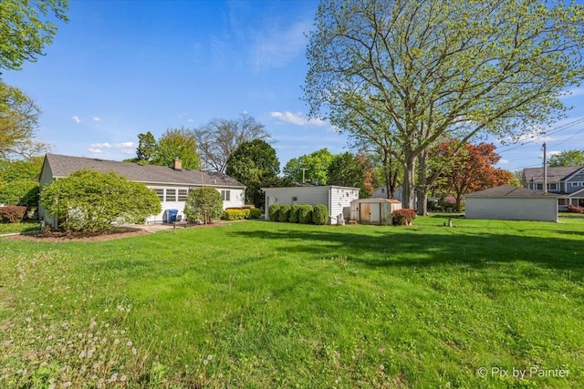 1029 S 5th St, Saint Charles, IL 60174 - view of green lawn with a storage unit and an outbuilding