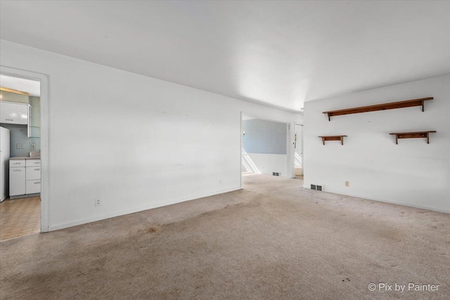 1029 S 5th St, Saint Charles, IL 60174 - unfurnished living room with carpet flooring and baseboards