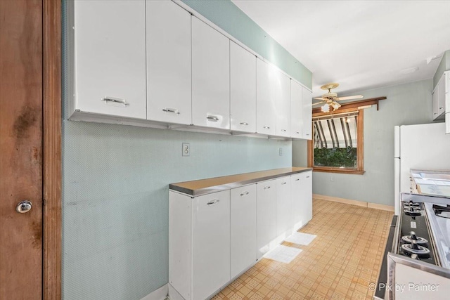 1029 S 5th St, Saint Charles, IL 60174 - kitchen with ceiling fan, white cabinetry, stovetop, and baseboards
