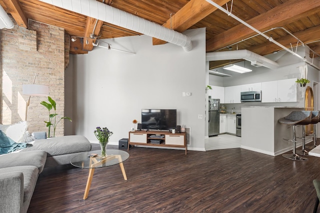 225 W Huron St Unit 402, Chicago, IL 60654 - living area with beam ceiling, wooden ceiling, wood finished floors, a high ceiling, and baseboards