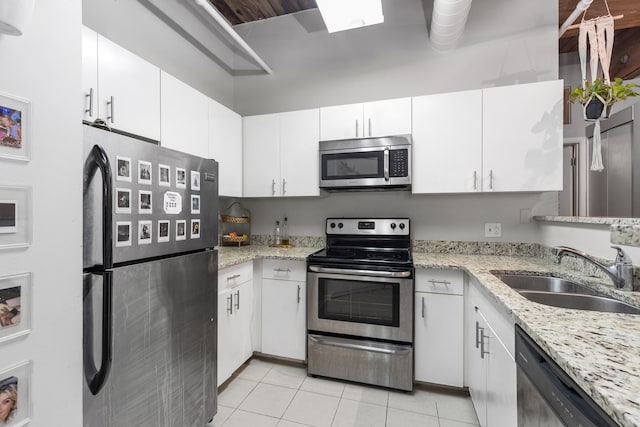 225 W Huron St Unit 402, Chicago, IL 60654 - kitchen featuring stainless steel appliances, a sink, white cabinetry, and light tile patterned floors