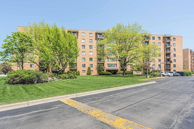 view of apartment building / complex featuring uncovered parking
