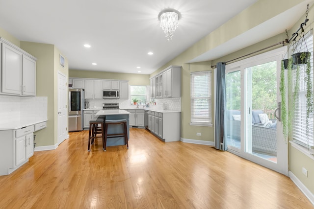 1984 Seaview Dr, Aurora, IL 60503 - kitchen with stainless steel appliances, gray cabinets, decorative backsplash, a center island, and recessed lighting