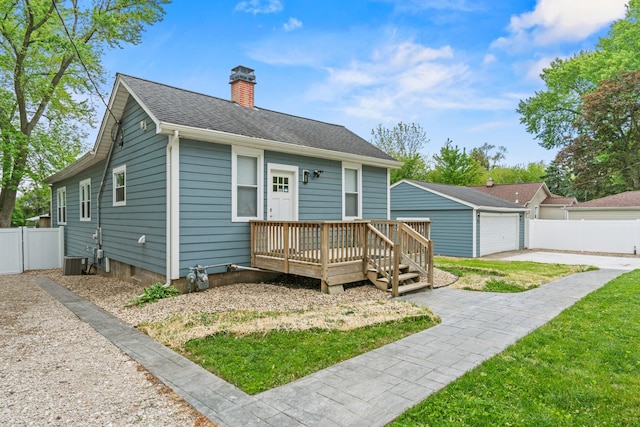 28271 W Stewart Ave, Spring Grove, IL 60081 - view of front of property with a chimney, a detached garage, a deck, cooling unit, and an outdoor structure
