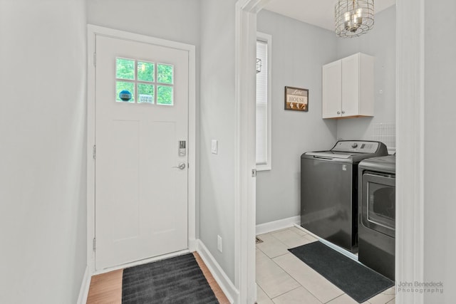 28271 W Stewart Ave, Spring Grove, IL 60081 - washroom with independent washer and dryer, cabinet space, baseboards, and a chandelier