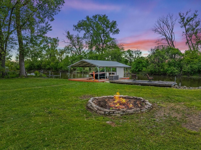 28271 W Stewart Ave, Spring Grove, IL 60081 - view of green lawn with a fire pit, a dock, a carport, and view of scattered trees