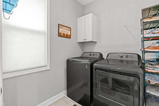 28271 W Stewart Ave, Spring Grove, IL 60081 - laundry area with washing machine and clothes dryer, cabinet space, baseboards, and tile patterned flooring