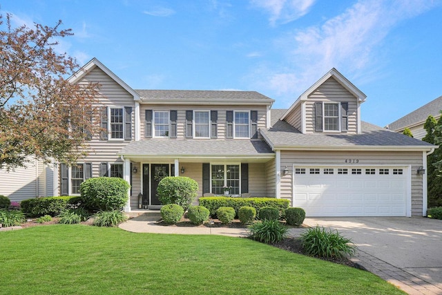 view of front of property featuring a garage, concrete driveway, a front lawn, roof with shingles, and a porch