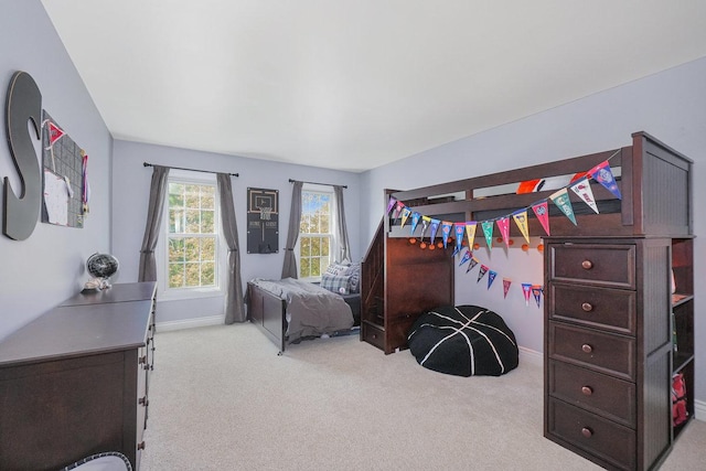 carpeted bedroom featuring baseboards