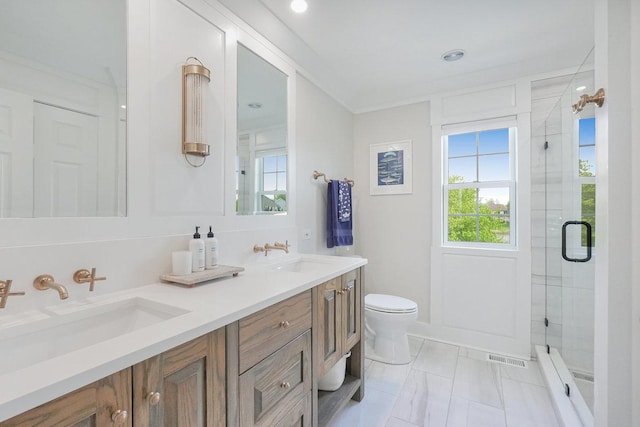 full bathroom featuring a stall shower, toilet, double vanity, and marble finish floors