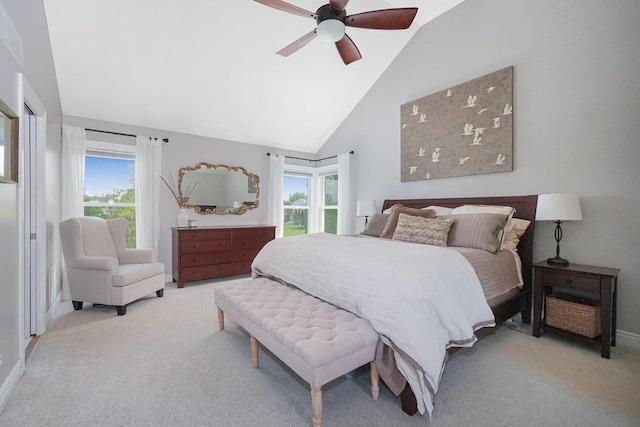bedroom featuring light colored carpet, multiple windows, ceiling fan, and high vaulted ceiling