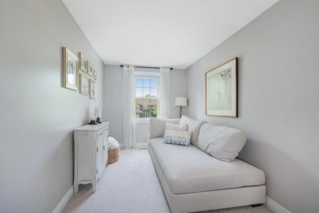 living room featuring baseboards and light colored carpet