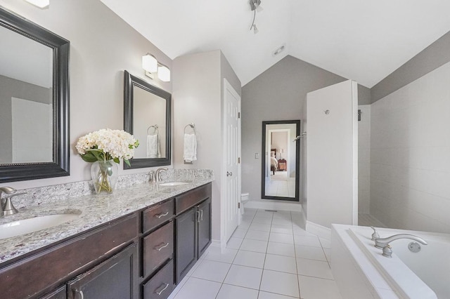 full bath with tile patterned flooring, toilet, lofted ceiling, double vanity, and baseboards