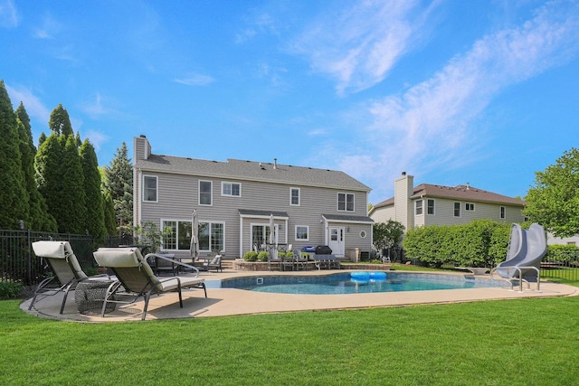 back of house featuring a patio and a chimney