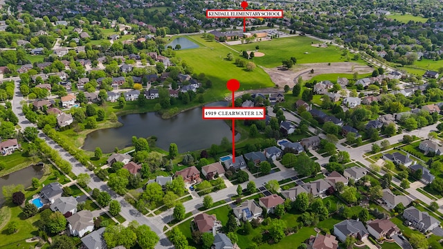 aerial perspective of suburban area with a nearby body of water