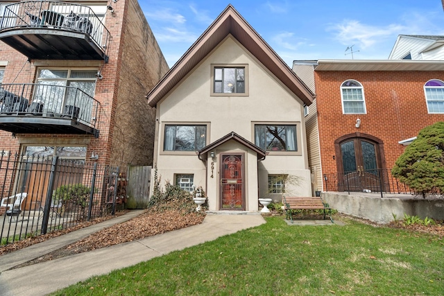 6914 S Cregier Ave, Chicago, IL 60649 - view of front of home featuring stucco siding, french doors, a balcony, and brick siding