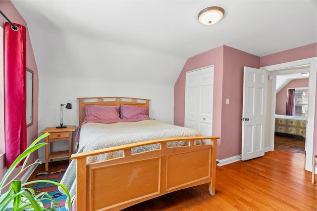 6914 S Cregier Ave, Chicago, IL 60649 - bedroom with light wood-style flooring, lofted ceiling, and baseboards