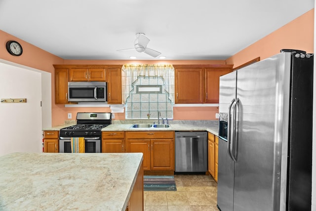 6914 S Cregier Ave, Chicago, IL 60649 - kitchen featuring appliances with stainless steel finishes, a sink, light countertops, and a ceiling fan