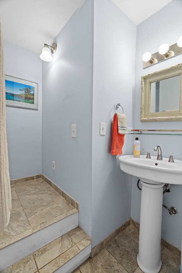 6914 S Cregier Ave, Chicago, IL 60649 - bathroom with stone tile flooring, baseboards, and a sink