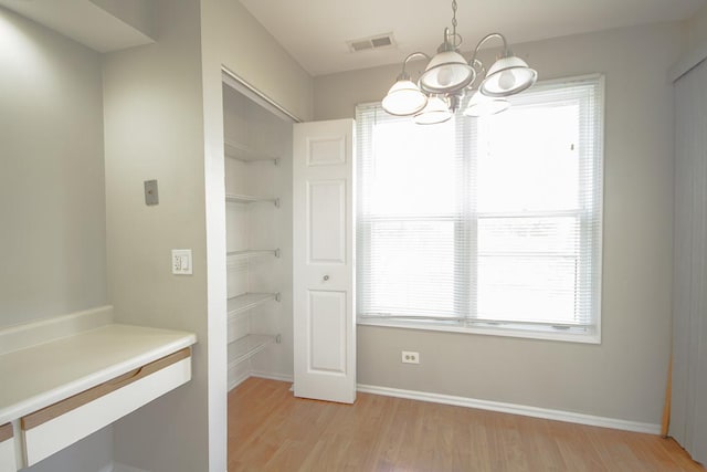 interior space with a chandelier and light wood-type flooring