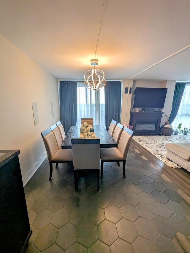465 W Dominion Dr Unit 1304, Wood Dale, IL 60191 - dining area featuring a chandelier, tile patterned floors, and baseboards