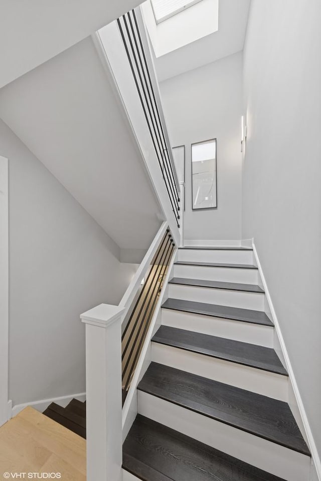 509 Burr Oak Pl, Hinsdale, IL 60521 - staircase featuring a skylight, baseboards, and wood finished floors