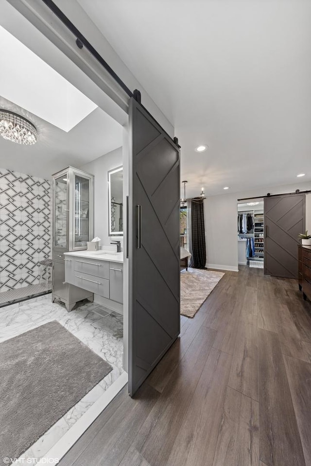 509 Burr Oak Pl, Hinsdale, IL 60521 - hallway with a barn door, recessed lighting, baseboards, a chandelier, and wood finished floors