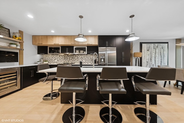 509 Burr Oak Pl, Hinsdale, IL 60521 - kitchen with stainless steel fridge with ice dispenser, beverage cooler, dark cabinets, tasteful backsplash, and recessed lighting
