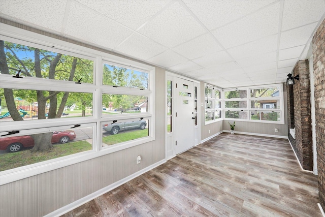 224 S 8th St, Dekalb, IL 60115 - unfurnished sunroom with wood finished floors, baseboards, and a drop ceiling
