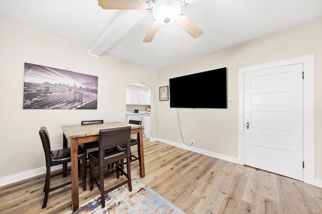 224 S 8th St, Dekalb, IL 60115 - dining room featuring beamed ceiling, arched walkways, light wood-style floors, a ceiling fan, and baseboards