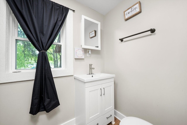 224 S 8th St, Dekalb, IL 60115 - bathroom featuring baseboards, vanity, and toilet