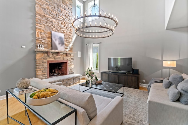 8260 W Argyle St, Norridge, IL 60706 - living area with a chandelier, wood finished floors, baseboards, a high ceiling, and a stone fireplace