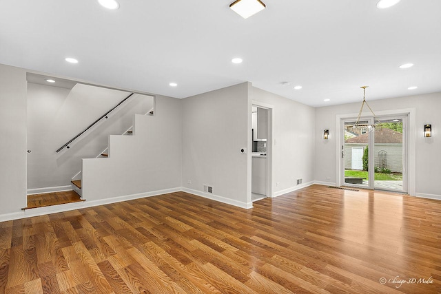 5935 Carol Ave, Morton Grove, IL 60053 - unfurnished living room featuring wood finished floors, stairs, baseboards, and recessed lighting