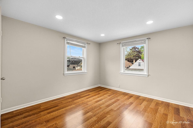 5935 Carol Ave, Morton Grove, IL 60053 - unfurnished room featuring plenty of natural light, baseboards, wood finished floors, and recessed lighting