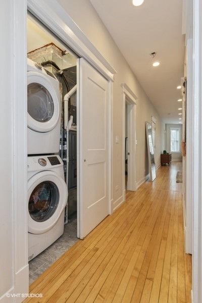 2151 W Cortez St, Chicago, IL 60622 - laundry room featuring stacked washer / dryer, light wood-type flooring, and recessed lighting