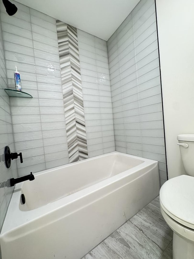 full bath featuring toilet, a bathtub, and wood finished floors