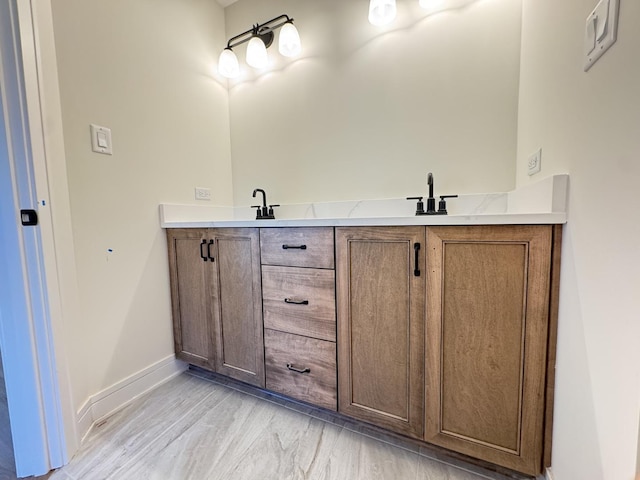 full bathroom with baseboards and double vanity
