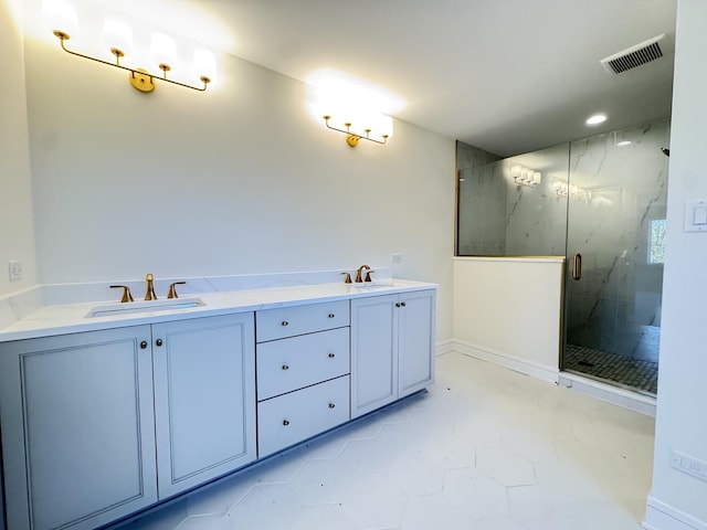 bathroom with a marble finish shower, recessed lighting, double vanity, and baseboards
