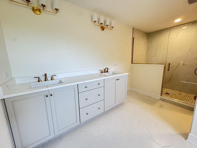 full bathroom featuring a sink, a shower stall, and tile patterned flooring
