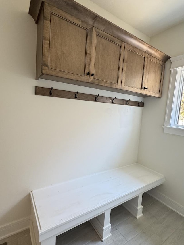 mudroom with baseboards and light wood finished floors