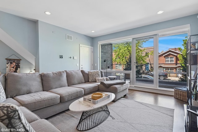 living area with wood finished floors and recessed lighting