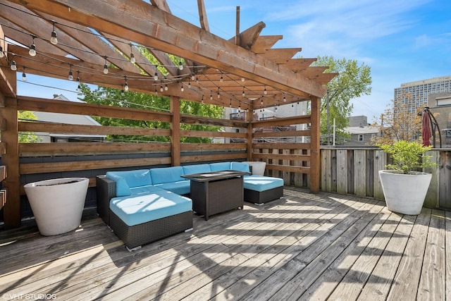 wooden terrace with a pergola and an outdoor living space