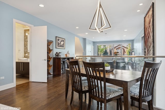 dining area with wood finished floors and recessed lighting