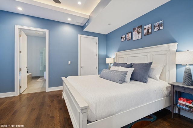 bedroom featuring dark wood-style flooring, recessed lighting, baseboards, and connected bathroom