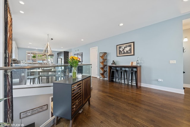 home office featuring wood finished floors, recessed lighting, and baseboards