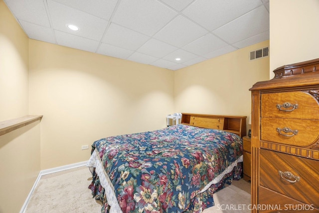 carpeted bedroom featuring baseboards, a drop ceiling, and recessed lighting