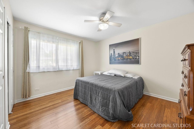 bedroom with wood finished floors, baseboards, and ceiling fan