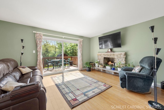 living area featuring wood finished floors and a fireplace