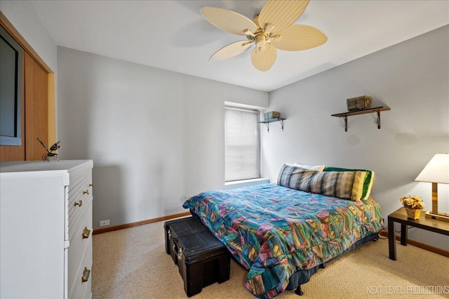 bedroom with light colored carpet, baseboards, and ceiling fan
