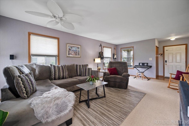 carpeted living room featuring plenty of natural light and a ceiling fan